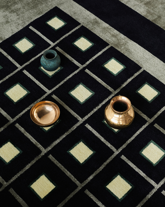 Detail of the Anton rug showing hand-knotted texture and tonal geometric repeat