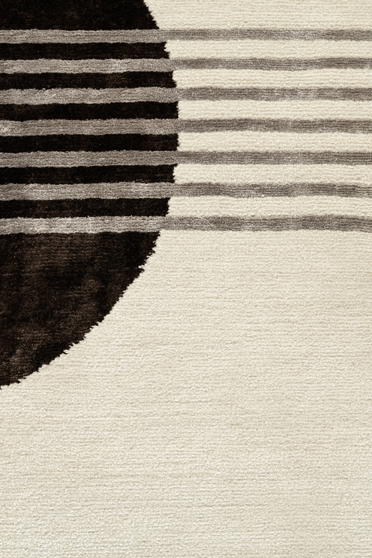 Close detail of the Jean rug by Scott's Shop, hand-knotted New Zealand wool and bamboo silk, showing colour field boundary between dark brown and cream pile