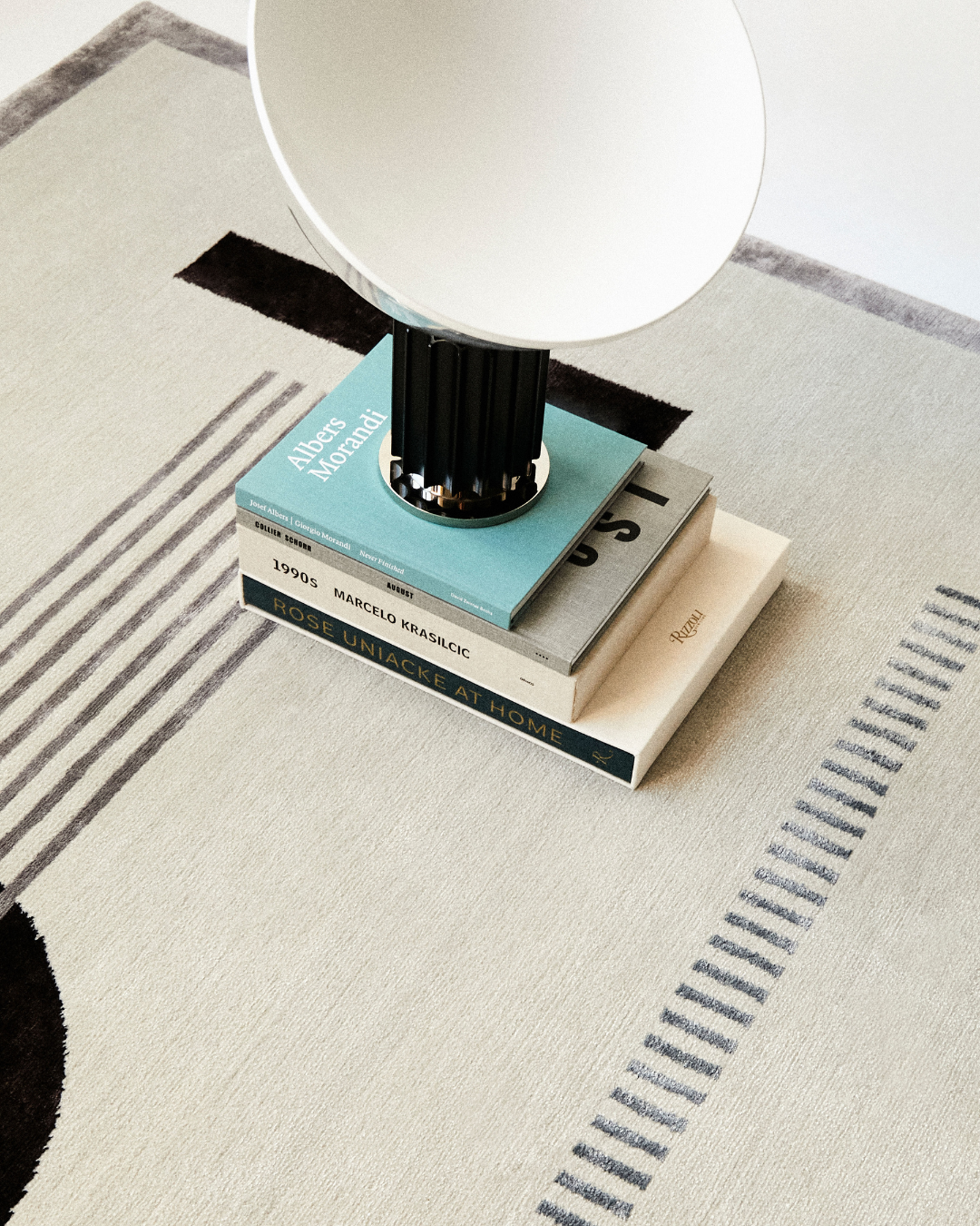 Close-up of the Jean rug's intricate hand-knotted craftsmanship, highlighting the smooth texture of bamboo silk and wool fibers in soft blue and cream.