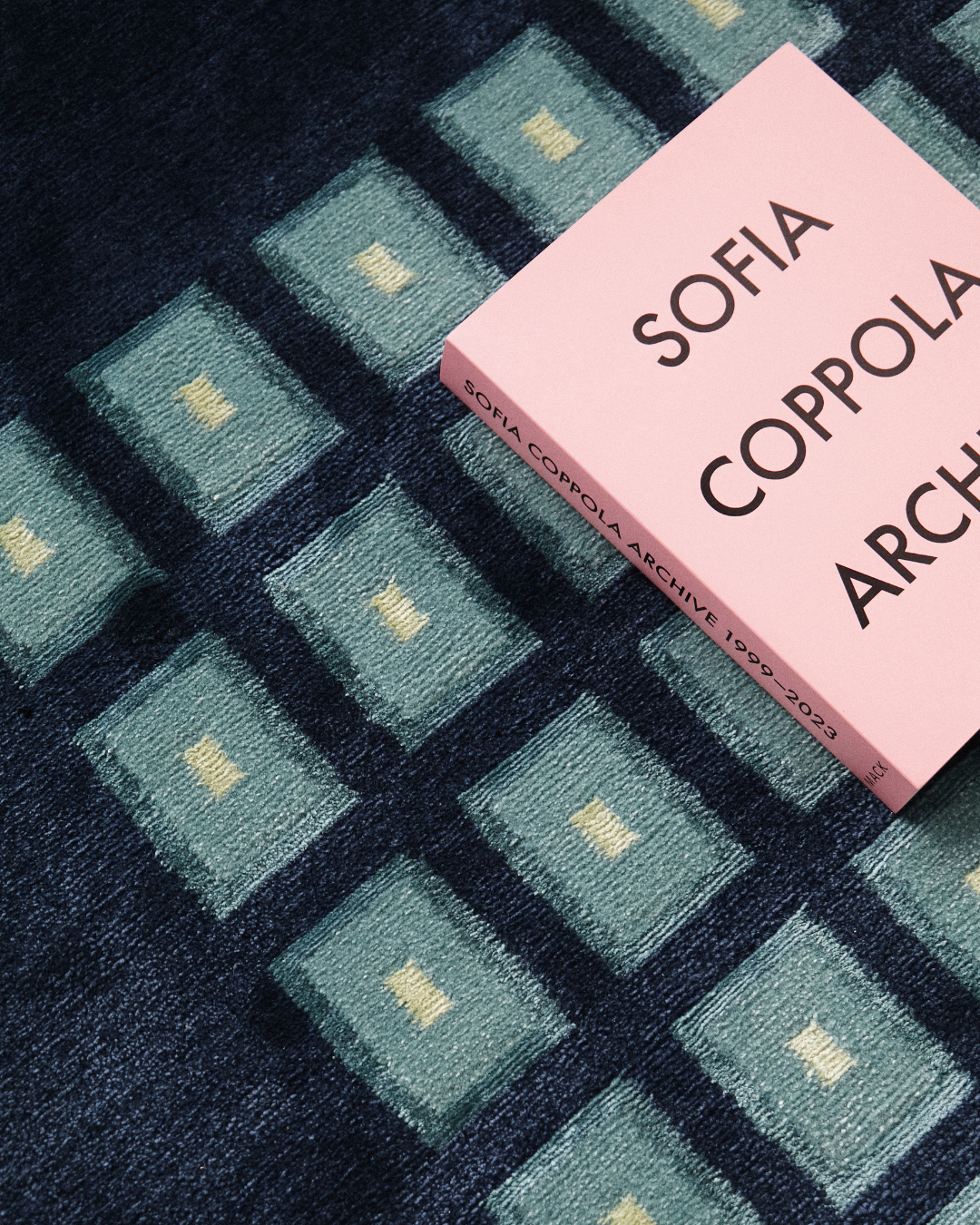 Detail of our Josef rug, hand-knotted in Nepal out of wool and bamboo silk. Featuring geometric squares of teal and pale yellow. 