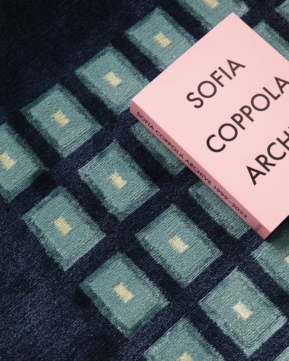 Detail of our Josef rug, hand-knotted in Nepal out of wool and bamboo silk. Featuring geometric squares of teal and pale yellow. 