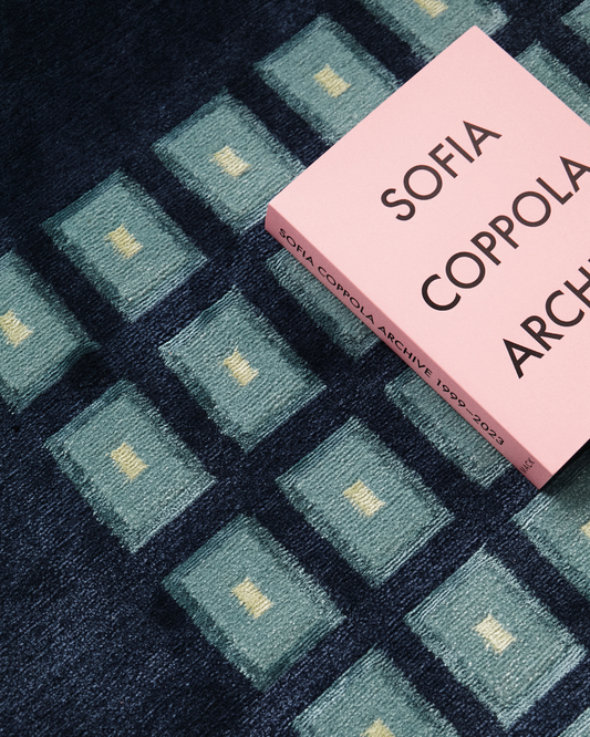 Detail of our Josef rug, hand-knotted in Nepal out of wool and bamboo silk. Featuring geometric squares of teal and pale yellow. 