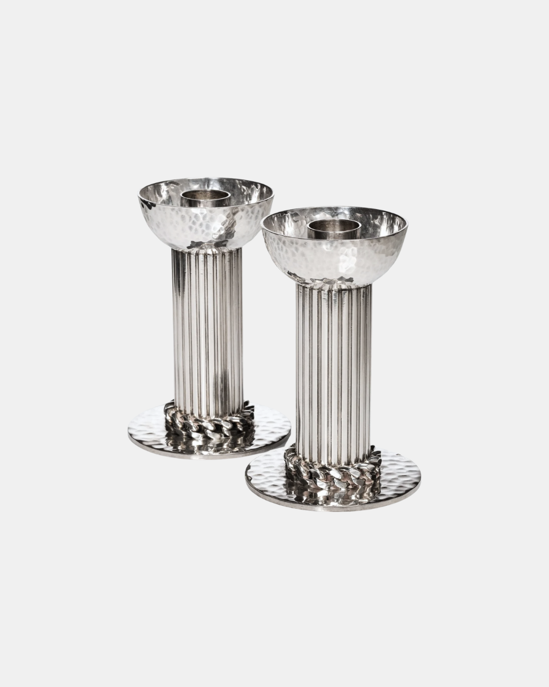 Silver-plated candlesticks by Jean Desprès. Fluted shafts, hammered bases and receptacles, curb chain collar.