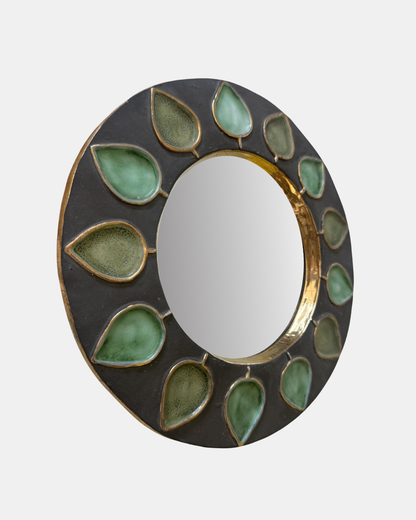 Mithé Espelt, Piques mirror, 1952. Grey glazed ceramic with green leaf decoration and gold lustre rim. Angled view showing depth of ceramic frame.