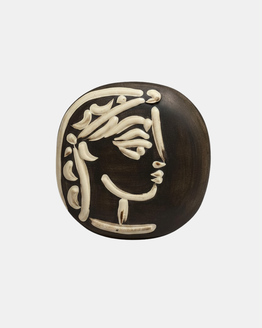 Pablo Picasso, Jacqueline's Profile, 1956. White stoneware with black patina and white glaze relief, Madoura. 18.5 × 18.5 cm.
