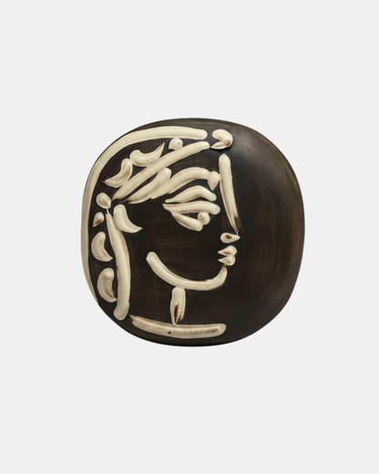 Pablo Picasso, Jacqueline's Profile, 1956. White stoneware with black patina and white glaze relief, Madoura. 18.5 × 18.5 cm.