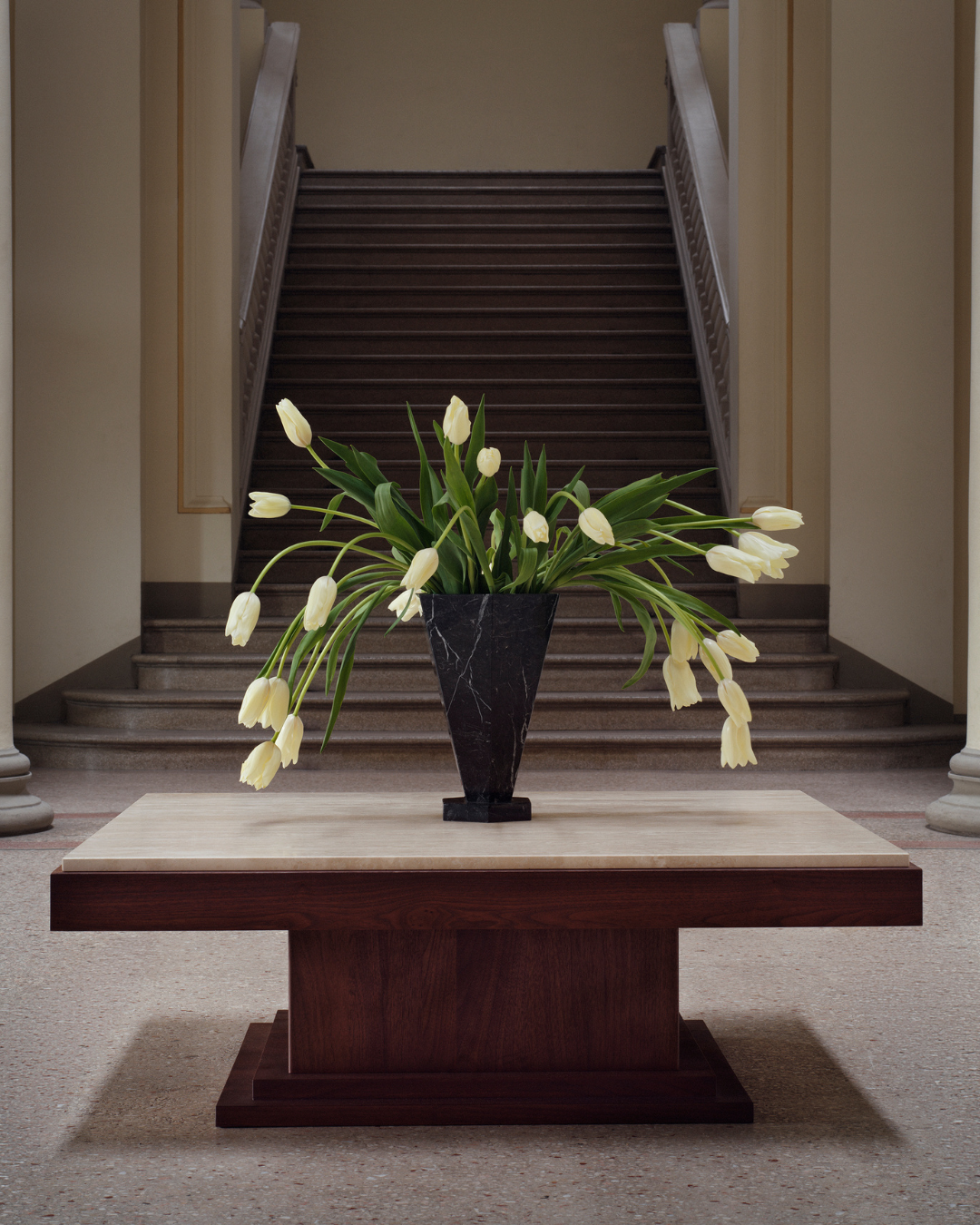 Black Marquina marble vase XL by Studio Vraco styled with white tulips on a wood and travertine table in neoclassical interior